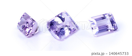 Amethyst, stone or rock in studio by white background for natural resource, jewelry and baguette for luxury. Gemstone, purple crystal and closeup with shine, glow and brilliant with cut for wealth Amethyst, stone or rock in studio by white background for natural resource, jewelry and baguette for luxury. Gemstone, purple crystal and closeup with shine, glow and brilliant with cut for wealth 140645733