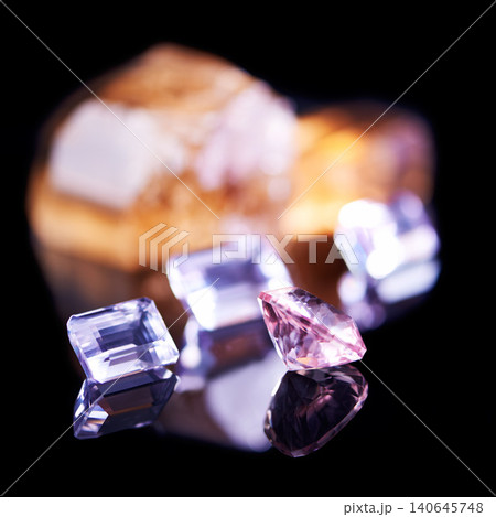 Gemstone, pink diamond and amethyst in studio with isolated black background for natural resource, jewel and sparkle for luxury. Rock, crystal and reflection in closeup for shine, glow and mineral Gemstone, pink diamond and amethyst in studio with isolated black background for natural resource, jewel and sparkle for luxury. Rock, crystal and reflection in closeup for shine, glow and mineral 140645748