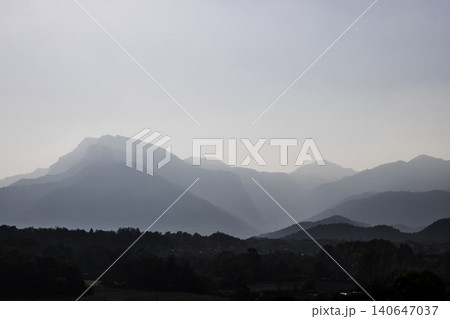 Layered mountain range with fog and haze Layered mountain range with fog and haze 140647037