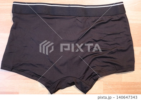 Black Men's Boxer Briefs on Wooden Floor 140647343