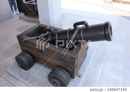 Vintage Cannon on Wooden Cart in Outdoor Plaza Vintage Cannon on Wooden Cart in Outdoor Plaza 140647349