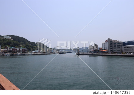 Harbor with Arch Bridge and Cityscape 140647355