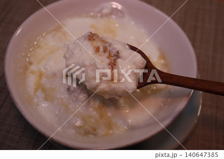 Spoonful of Congee in Bowl 140647385