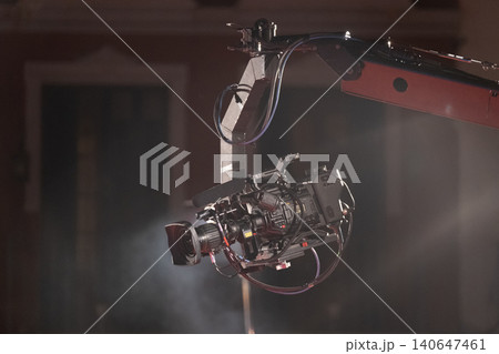 Dynamic shooting with a professional camera crane setup for film or TV production, capturing smooth high-angle shots for cinematic excellence. 140647461