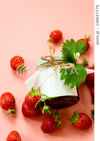Fresh strawberry preserve with ripe berries on soft pink backdrop Fresh strawberry preserve with ripe berries on soft pink backdrop 140647776