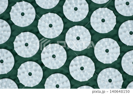 Macro abstract background of green acupuncture massage mat needles. 140648150