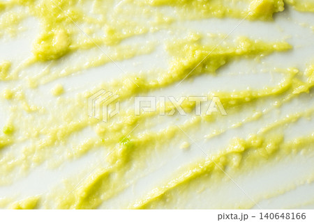 Abstract food art background with green avocado puree on white surface. 140648166