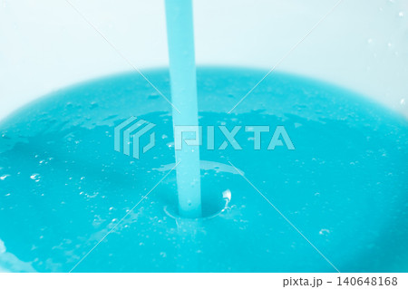 Pouring blue liquid detergent close up, abstract background. 140648168