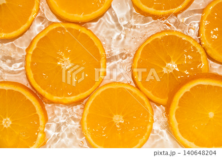 Fresh fruity background of orange slices in splash of water Fresh fruity background of orange slices in splash of water 140648204