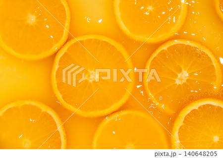 Fresh slices of oranges splashing in orange juice. Fruity bright background Fresh slices of oranges splashing in orange juice. Fruity bright background 140648205