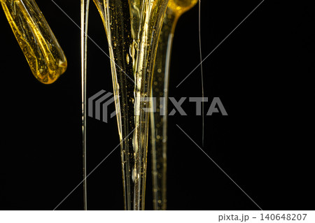 Macro Texture Of Liquid Fresh Honey On Black Background. Macro Texture Of Liquid Fresh Honey On Black Background. 140648207