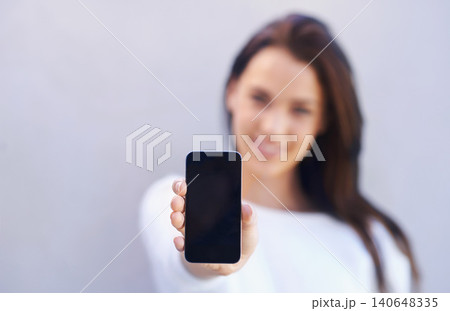Mockup, person and smartphone on gray background with screen for connectivity, communication and mobile with technology. Studio, cellphone and interaction with internet for chat or conversation 140648335