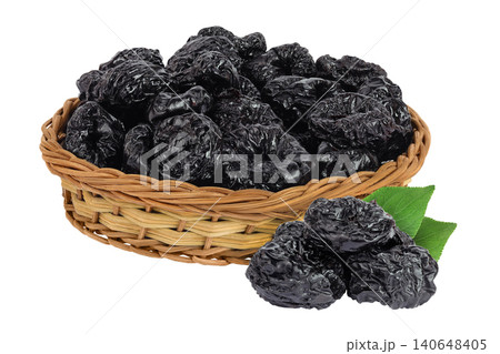 Prunes in a wicker basket isolated on white background, heap of dried plums Prunes in a wicker basket isolated on white background, heap of dried plums 140648405