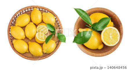 Ripe lemons in wicker basket and wooden bowl isolated on white background. Top view. Flat lay. 140648456
