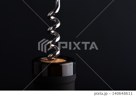 Corkscrew opening wine bottle with a cork Corkscrew opening wine bottle with a cork 140648611