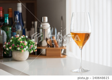 Wine glass with alcohol on bar counter, cocktail making tools Wine glass with alcohol on bar counter, cocktail making tools 140648615