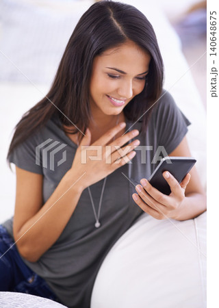 Woman, living room and sofa with smile on smartphone for online research or social media with networking. Female person, home and touchscreen on break for internet, video and entertainment. Woman, living room and sofa with smile on smartphone for online research or social media with networking. Female person, home and touchscreen on break for internet, video and entertainment. 140648675