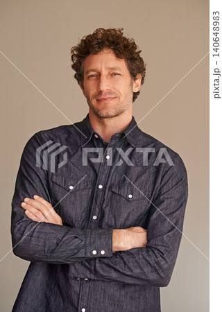 Mature man, portrait and confident in studio, smile and denim or casual fashion on brown background. Happy male person, positive and cool clothes or style, proud and satisfaction for aesthetic Mature man, portrait and confident in studio, smile and denim or casual fashion on brown background. Happy male person, positive and cool clothes or style, proud and satisfaction for aesthetic 140648983