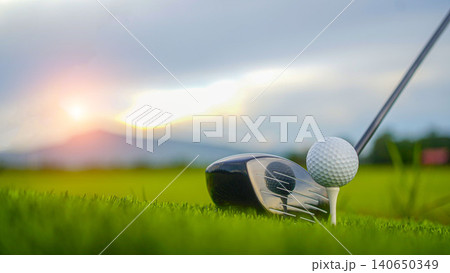 Golf clubs and balls on a green lawn in a beautiful golf course with morning sunshine. Golf clubs and balls on a green lawn in a beautiful golf course with morning sunshine. 140650349