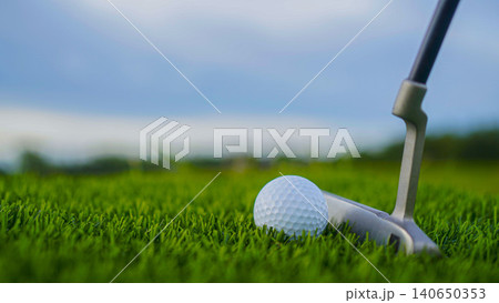 Golf clubs and balls on a green lawn in a beautiful golf course with morning sunshine. Golf clubs and balls on a green lawn in a beautiful golf course with morning sunshine. 140650353