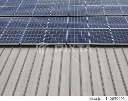 Wide Array of Solar Panels on Industrial Building Roof Wide Array of Solar Panels on Industrial Building Roof 140650403