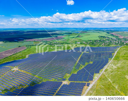 Solar installations blending into countryside vistas peacefully. Community sustainable energy solutions integrated within natural rural environments peacefully and efficiently Solar installations blending into countryside vistas peacefully. Community sustainable energy solutions integrated within natural rural environments peacefully and efficiently 140650666