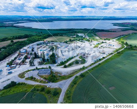 Snapshot capturing quarry extraction activities from above. Comprehensive aerial image depicting active quarry operations and gravel removal activities from elevated perspective Snapshot capturing quarry extraction activities from above. Comprehensive aerial image depicting active quarry operations and gravel removal activities from elevated perspective 140650668