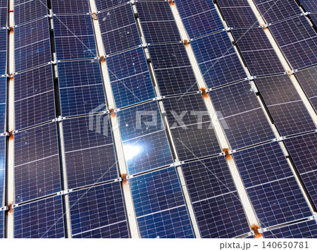 Views of solar panels installed on a rooftop in a sunny location during the daytime showing multiple rows in a grid pattern Views of solar panels installed on a rooftop in a sunny location during the daytime showing multiple rows in a grid pattern 140650781