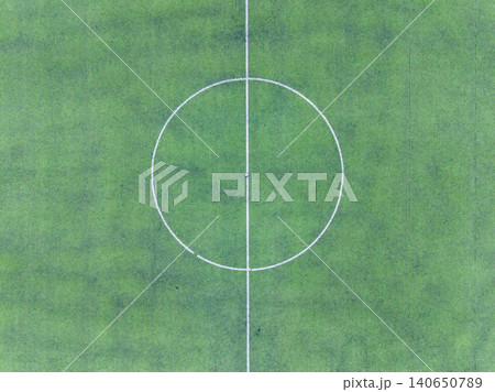 Soccer field layout showing center circle and midline during sunny day in a local park or sports complex 140650789