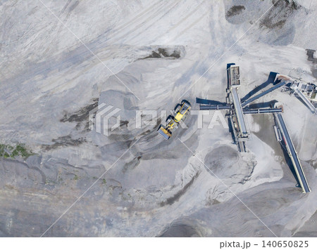 Granite quarry operation in progress with heavy machinery and mineral extraction activity visible Granite quarry operation in progress with heavy machinery and mineral extraction activity visible 140650825