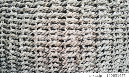 Natural woven pouf ottoman stool for living room interior 140651475