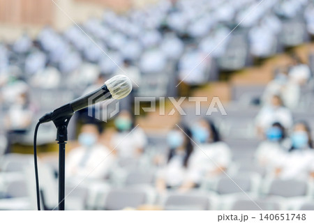 Close up of microphone over abstract blurred of attendee in seminar room or conference hall 140651748