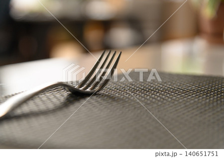 Close-up dining fork silver on table in restaurant with copy space. Design and diet concept Close-up dining fork silver on table in restaurant with copy space. Design and diet concept 140651751