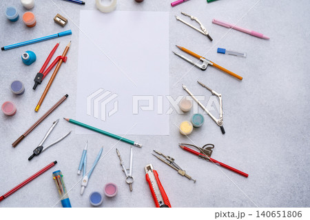 Engineering study workspace with blank white paper, various supplies back to school background. Draw brushes, pencils drawing compasses stationery tools Engineering study workspace with blank white paper, various supplies back to school background. Draw brushes, pencils drawing compasses stationery tools 140651806