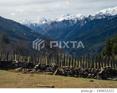 Rugged wooden fence lines grassy field Rugged wooden fence lines grassy field 140652221