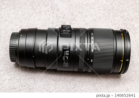 Professional Telephoto Zoom Camera Lens on Textured Surface Professional Telephoto Zoom Camera Lens on Textured Surface 140652641