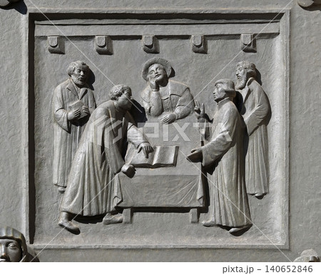 Luther and Zwingli dispute about the Lord's Supper at Marburg, relief on the door of the Grossmunster ("great minster") church in Zurich, Switzerland Luther and Zwingli dispute about the Lord's Supper at Marburg, relief on the door of the Grossmunster ("great minster") church in Zurich, Switzerland 140652846