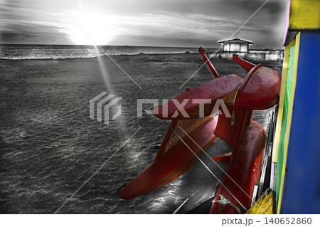 Red rescue boats on beach at sunset with selective color effect Red rescue boats on beach at sunset with selective color effect 140652860