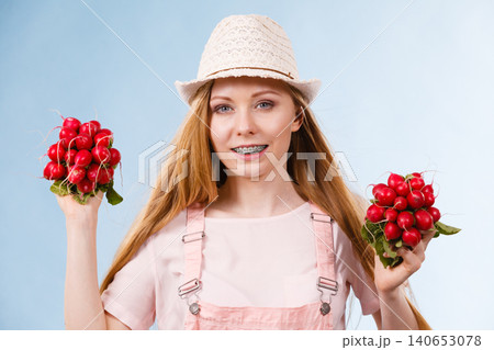 Happy woman giving radish Happy woman giving radish 140653078
