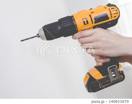 Hand holding yellow drill Hand holding yellow drill 140653079