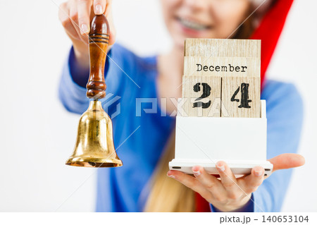 Woman and christmas calendar with bell 140653104