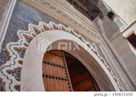 Monumental entrance of the Nejjarine Museum with a Moorish arch carved in wood and mosaics in the medina of Fez Monumental entrance of the Nejjarine Museum with a Moorish arch carved in wood and mosaics in the medina of Fez 140653350