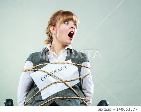 Afraid businesswoman bound by contract terms. Afraid businesswoman bound by contract terms. 140653377