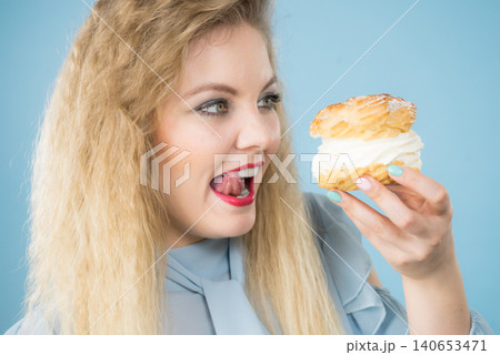 Funny woman holds cream puff cake Funny woman holds cream puff cake 140653471