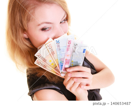 Economy finance. Woman holds euro currency money. 140653487