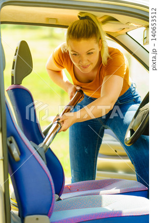 Cleaning car interior with vacuum cleaner Cleaning car interior with vacuum cleaner 140653512
