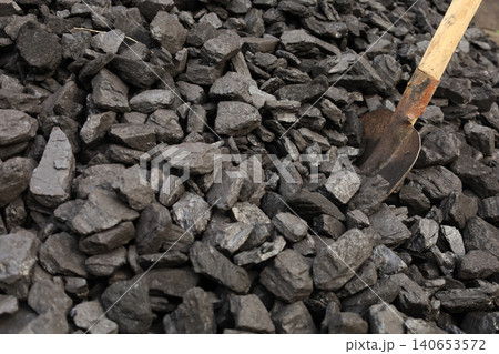 Dark coal litters the ground, coarse and wet 140653572