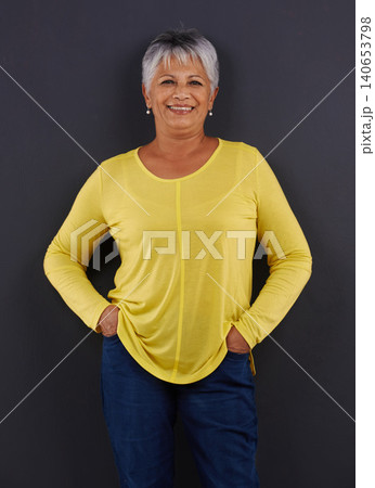 Smile, fashion and portrait of woman in studio with casual, trendy and bright tshirt for outfit. Confident, happy and senior female person from Mexico with cool style isolated by black background. Smile, fashion and portrait of woman in studio with casual, trendy and bright tshirt for outfit. Confident, happy and senior female person from Mexico with cool style isolated by black background. 140653798