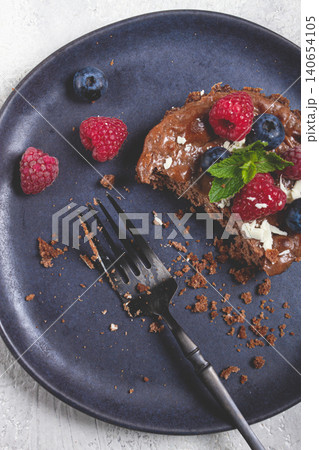 half-eaten chocolate tartlet, on a plate, stuffed with cottage cheese and berries, breakfast, homemade, no people, half-eaten chocolate tartlet, on a plate, stuffed with cottage cheese and berries, breakfast, homemade, no people, 140654105