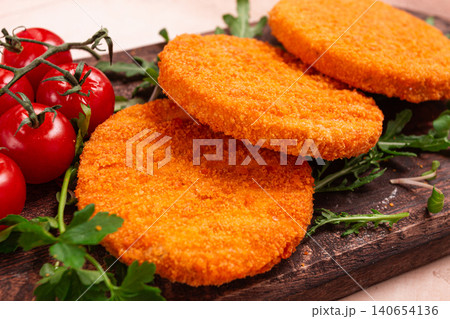 crispy fried fish cutlets, fish burgers, on a wooden chopping board, with arugula and cherry tomatoes, homemade, no people, crispy fried fish cutlets, fish burgers, on a wooden chopping board, with arugula and cherry tomatoes, homemade, no people, 140654136